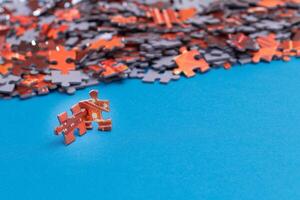 Mixed Pieces of a Colorful Jigsaw Puzzle Lie on the Blue Background With Copy Space - Strategy and Solving Problem Concept photo