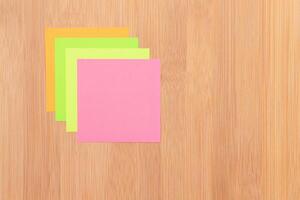Colored Sticky Notes with Copyspace Pinned to the Wooden Message Board. To Do List Reminder in Office. Blank Memo Sticker at Work - Template. Empty Checklist - Mockup photo