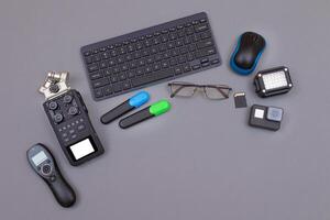 Top View of Blogger's Workplace. Digital Gadgets Lying on Grey Table - Flat Lay photo
