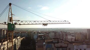 Yellow crane under construction. Construction site with yellow crane and building on background of sky video