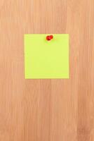 Yellow Sticky Note Pinned to the Wooden Message Board. To Do List Reminder in Office. Blank Memo Sticker at Work - Template. Empty Checklist - Mockup photo