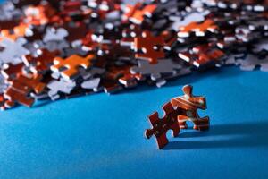 Mixed Pieces of a Colorful Jigsaw Puzzle Lie on the Blue Background - Strategy and Solving Problem Concept photo