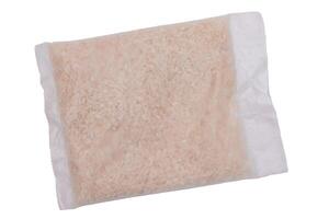 A Plastic Bag of White Long Grain Rice - Isolated on White Background. Small Transparent Package with Dry Rice - Isolation photo