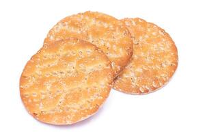 A Heap of Round Salt Crackers with Sesame Isolated on White Background. Dry Snacks - Isolation photo