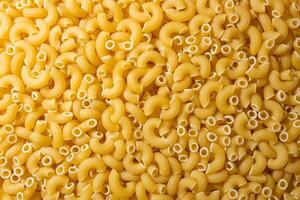 Uncooked Chifferi Rigati Pasta. A Culinary Canvas of Chifferi Rigati, Creating a Lively and Textured Background for Gourmet Cooking. Dry Pasta. Raw Macaroni - Top View, Flat Lay photo