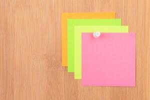 Colored Sticky Notes with Copyspace Pinned to the Wooden Message Board. To Do List Reminder in Office. Blank Memo Sticker at Work - Template. Empty Checklist - Mockup photo