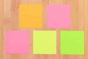Colored Sticky Notes with Copyspace Pinned to the Wooden Message Board. To Do List Reminder in Office. Blank Memo Sticker at Work - Template. Empty Checklist - Mockup photo