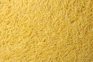 Uncooked Filini Pasta. A Culinary Canvas of Noodles, Creating a Lively and Textured Background for Gourmet Cooking. Dry Pasta. Raw Macaroni - Top View, Flat Lay photo