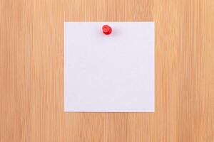 White Sticky Note with Copyspace Pinned to the Wooden Message Board. To Do List Reminder in Office. Blank Memo Sticker at Work - Template. Empty Checklist - Mockup photo
