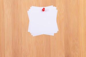 White Sticky Notes with Copyspace Pinned to the Wooden Message Board. To Do List Reminder in Office. Blank Memo Stickers at Work - Template. Empty Checklist - Mockup photo