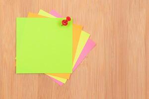 Colored Sticky Notes with Copyspace Pinned to the Wooden Message Board. To Do List Reminder in Office. Blank Memo Sticker at Work - Template. Empty Checklist - Mockup photo
