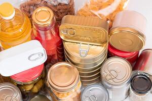 Food Reserves. Canned Food, Spaghetti, Pate, Tuna, Tomato Juice, Pasta, Fish and Grocery. Emergency Food Storage in Case of Crisis. Strategic Food Supplies photo