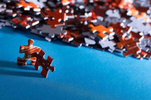 Mixed Pieces of a Colorful Jigsaw Puzzle Lie on the Blue Background - Strategy and Solving Problem Concept photo