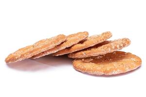 A Heap of Round Salt Crackers with Sesame Isolated on White Background. Dry Snacks - Isolation photo