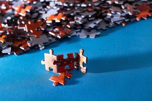 Mixed Pieces of a Colorful Jigsaw Puzzle Lie on the Blue Background - Strategy and Solving Problem Concept photo