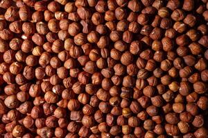 Scattered Peeled Hazelnut - Top View. Background from Hazelnuts. Natural High-Calorie Snacks photo