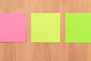 Colored Sticky Notes with Copyspace Pinned to the Wooden Message Board. To Do List Reminder in Office. Blank Memo Sticker at Work - Template. Empty Checklist - Mockup photo