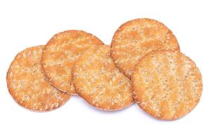 A Heap of Round Salt Crackers with Sesame Isolated on White Background. Dry Snacks - Isolation photo