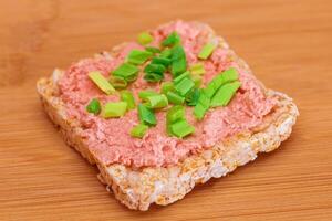 Rice Cake Sandwich with Fish Cream and Green Onions on Bamboo Cutting Board. Easy Breakfast. Diet Food. Quick and Healthy Sandwiches. Crispbread with Tasty Filling. Healthy Dietary Snack photo