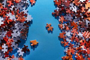 Mixed Pieces of a Colorful Jigsaw Puzzle Lie on the Blue Background - Strategy and Solving Problem Concept photo