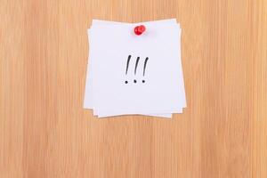 White Sticky Notes with Three Exclamation Points Pinned to the Wooden Message Board. To Do List Reminder in the Office. Memo Note at Work photo