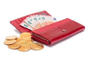 Opened Red Women Purse with 10 Euro Banknotes Inside and Bitcoin Coins - Isolated on White Background. A Wallet Full of Money Symbolizing Wealth, Success, Shopping and Social Status - Isolation photo