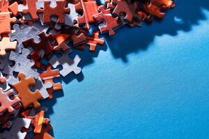 Mixed Pieces of a Colorful Jigsaw Puzzle Lie on the Blue Background With Copy Space - Strategy and Solving Problem Concept photo