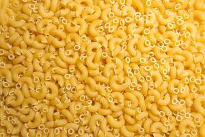 Uncooked Chifferi Rigati Pasta. A Culinary Canvas of Chifferi Rigati, Creating a Lively and Textured Background for Gourmet Cooking. Dry Pasta. Raw Macaroni - Top View, Flat Lay photo