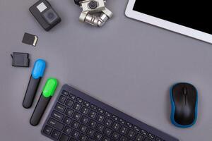 Top View of Blogger's Workplace. Digital Gadgets Lying on Grey Table - Flat Lay photo