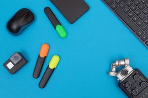 Top View of Photographer's, Videographer's or Blogger's Workplace. Digital Gadgets Lying on Blue Table - Flat Lay photo
