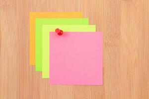 Colored Sticky Notes with Copyspace Pinned to the Wooden Message Board. To Do List Reminder in Office. Blank Memo Sticker at Work - Template. Empty Checklist - Mockup photo