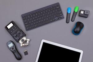Top View of Blogger's Workplace. Digital Gadgets Lying on Grey Table - Flat Lay photo