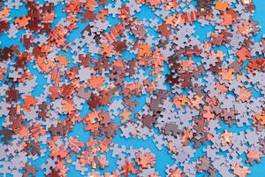 Top View of Mixed Pieces of a Jigsaw Puzzle - Texture Background photo