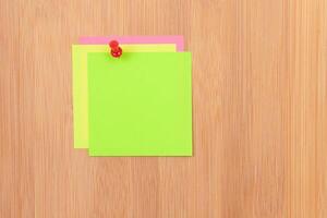 Colored Sticky Notes with Copyspace Pinned to the Wooden Message Board. To Do List Reminder in Office. Blank Memo Sticker at Work - Template. Empty Checklist - Mockup photo