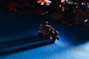 Mixed Pieces of a Colorful Jigsaw Puzzle Lie on the Blue Background - Strategy and Solving Problem Concept photo