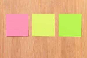 Colored Sticky Notes with Copyspace Pinned to the Wooden Message Board. To Do List Reminder in Office. Blank Memo Sticker at Work - Template. Empty Checklist - Mockup photo