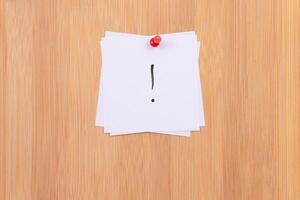 White Sticky Notes with Exclamation Point Pinned to the Wooden Message Board. To Do List Reminder in the Office. Memo Note at Work photo