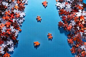 Mixed Pieces of a Colorful Jigsaw Puzzle Lie on the Blue Background - Strategy and Solving Problem Concept photo