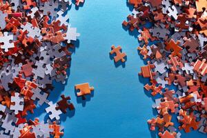 Mixed Pieces of a Colorful Jigsaw Puzzle Lie on the Blue Background - Strategy and Solving Problem Concept photo