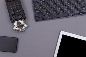 Top View of Workplace. Digital Gadgets Lying on Grey Table - Flat Lay photo