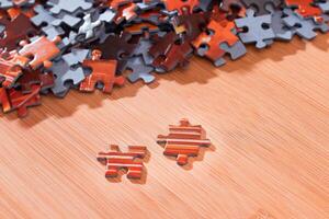 Colorful Pieces of a Mixed Jigsaw Puzzle Lie on the Wooden Table - Strategy and Solving Problem Concept photo