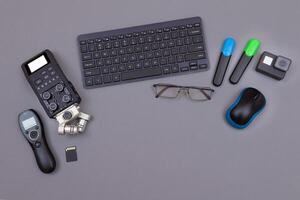Top View of Blogger's Workplace. Digital Gadgets Lying on Grey Table - Flat Lay photo