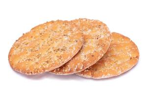 A Heap of Round Salt Crackers with Sesame Isolated on White Background. Dry Snacks - Isolation photo