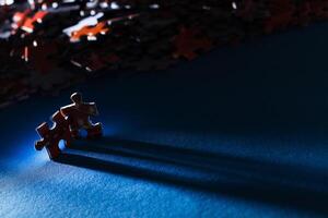 Mixed Pieces of a Colorful Jigsaw Puzzle Lie on the Blue Background - Strategy and Solving Problem Concept photo