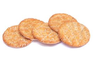 A Heap of Round Salt Crackers with Sesame Isolated on White Background. Dry Snacks - Isolation photo