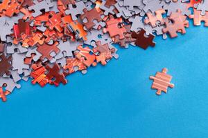 Mixed Pieces of a Colorful Jigsaw Puzzle Lie on the Blue Background - Strategy and Solving Problem Concept photo