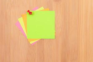 Colored Sticky Notes with Copyspace Pinned to the Wooden Message Board. To Do List Reminder in Office. Blank Memo Sticker at Work - Template. Empty Checklist - Mockup photo