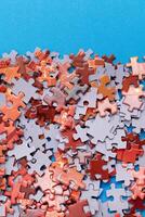 Mixed Pieces of a Colorful Jigsaw Puzzle Lie on the Blue Background - Strategy and Solving Problem Concept photo
