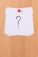 White Sticky Notes with Question Mark Pinned to the Wooden Message Board. To Do List Reminder in the Office. Memo Note at Work photo
