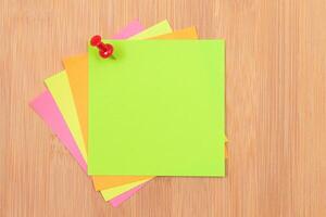 Colored Sticky Notes with Copyspace Pinned to the Wooden Message Board. To Do List Reminder in Office. Blank Memo Sticker at Work - Template. Empty Checklist - Mockup photo